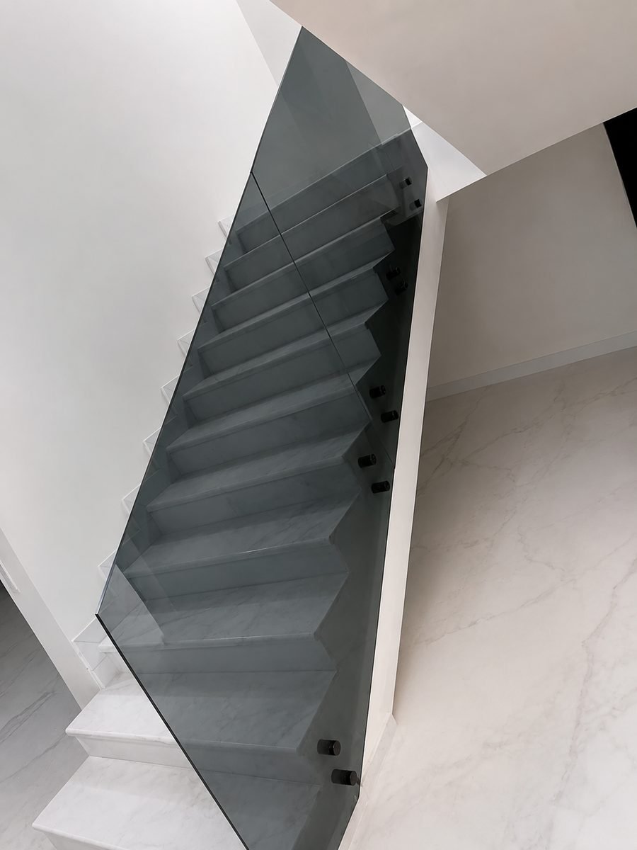 Smoked tempered-glass staircase balustrade with stainless fittings