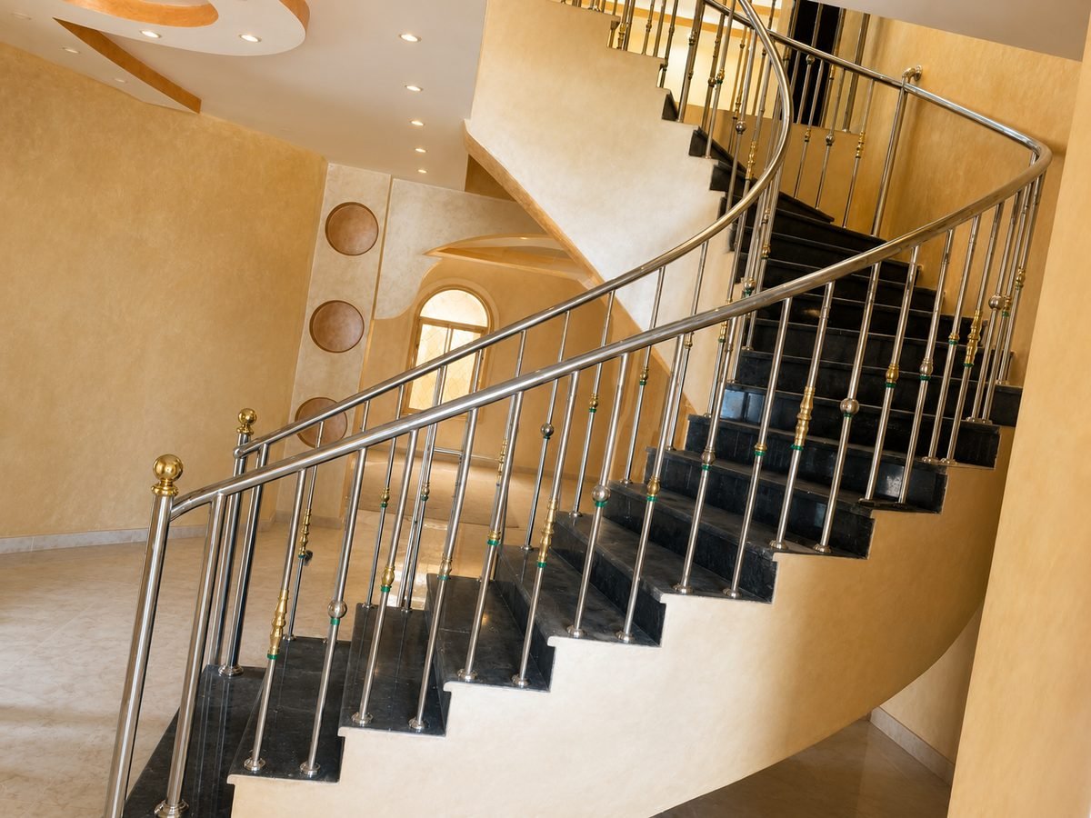 Steel and brass spiral staircase with a formed balustrade